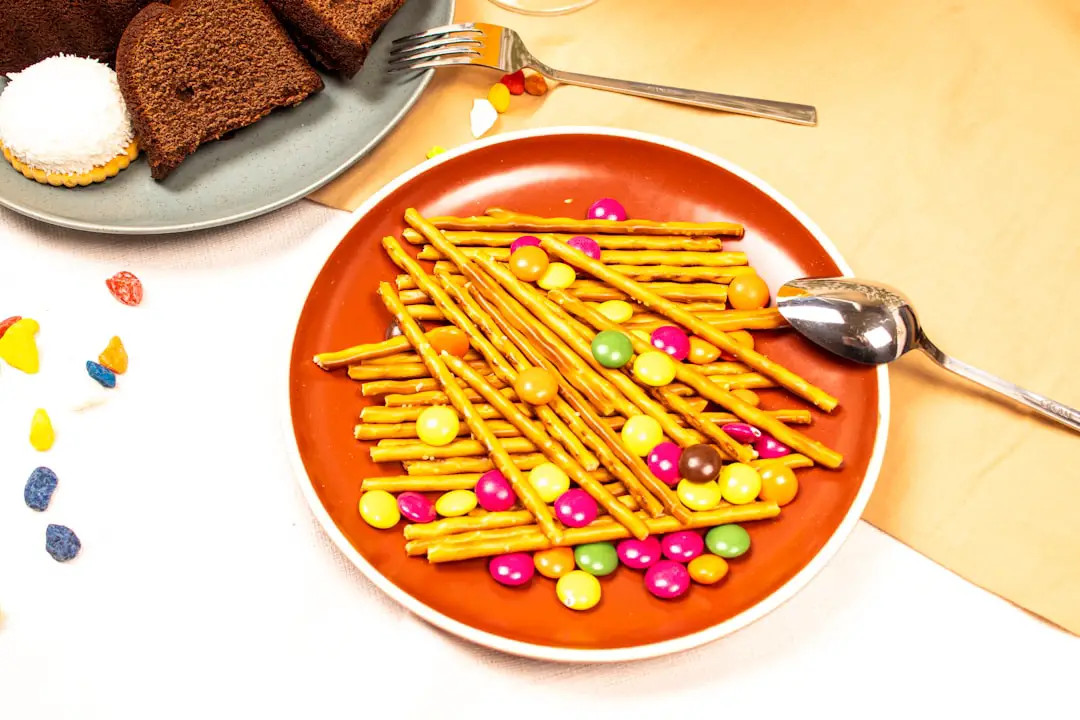 A plate of cake next to a plate of cookies