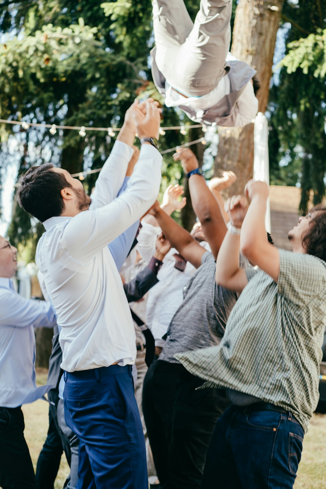 man in white dress shirt and blue denim jeans holding woman in white dress shirt