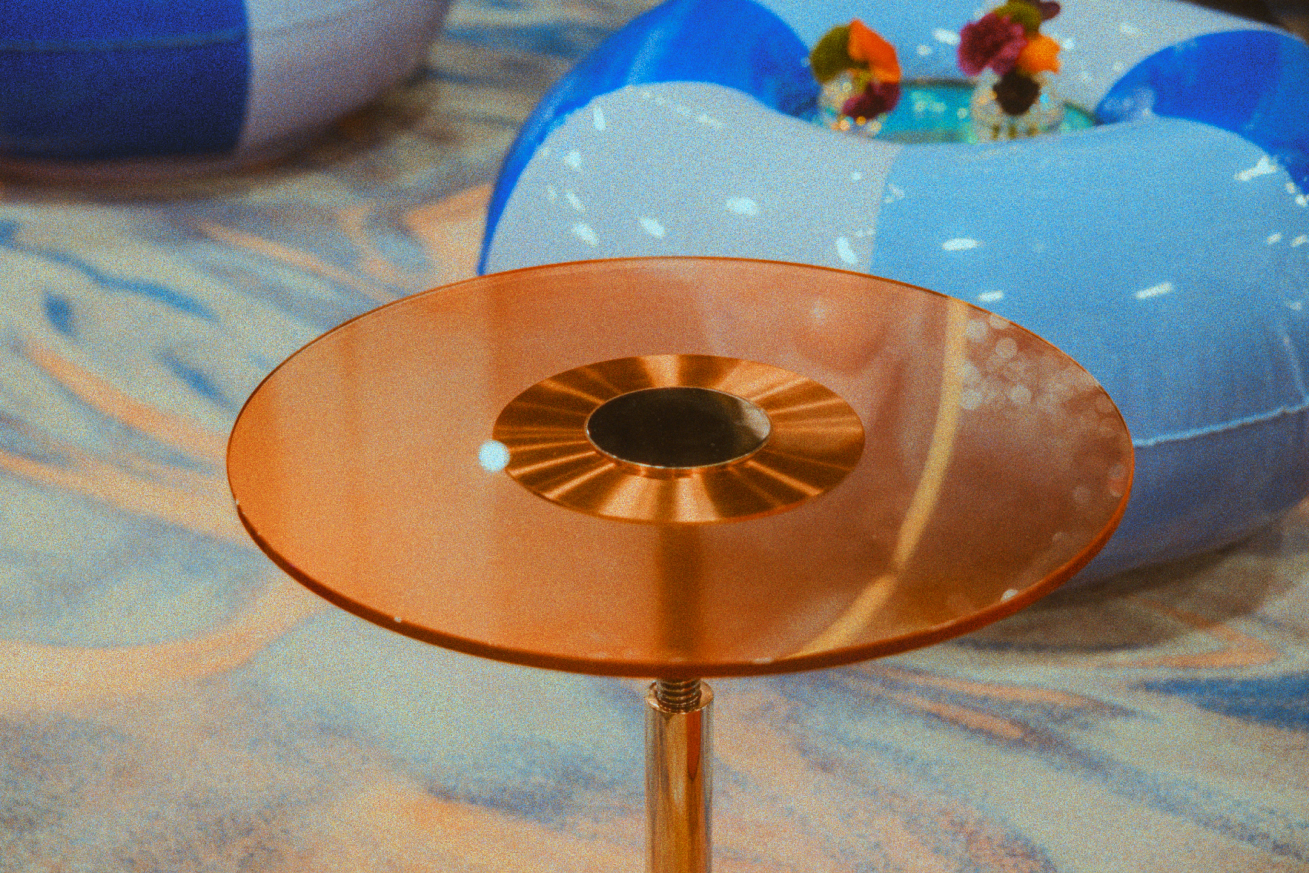 A copper table and a beach ball are in view.